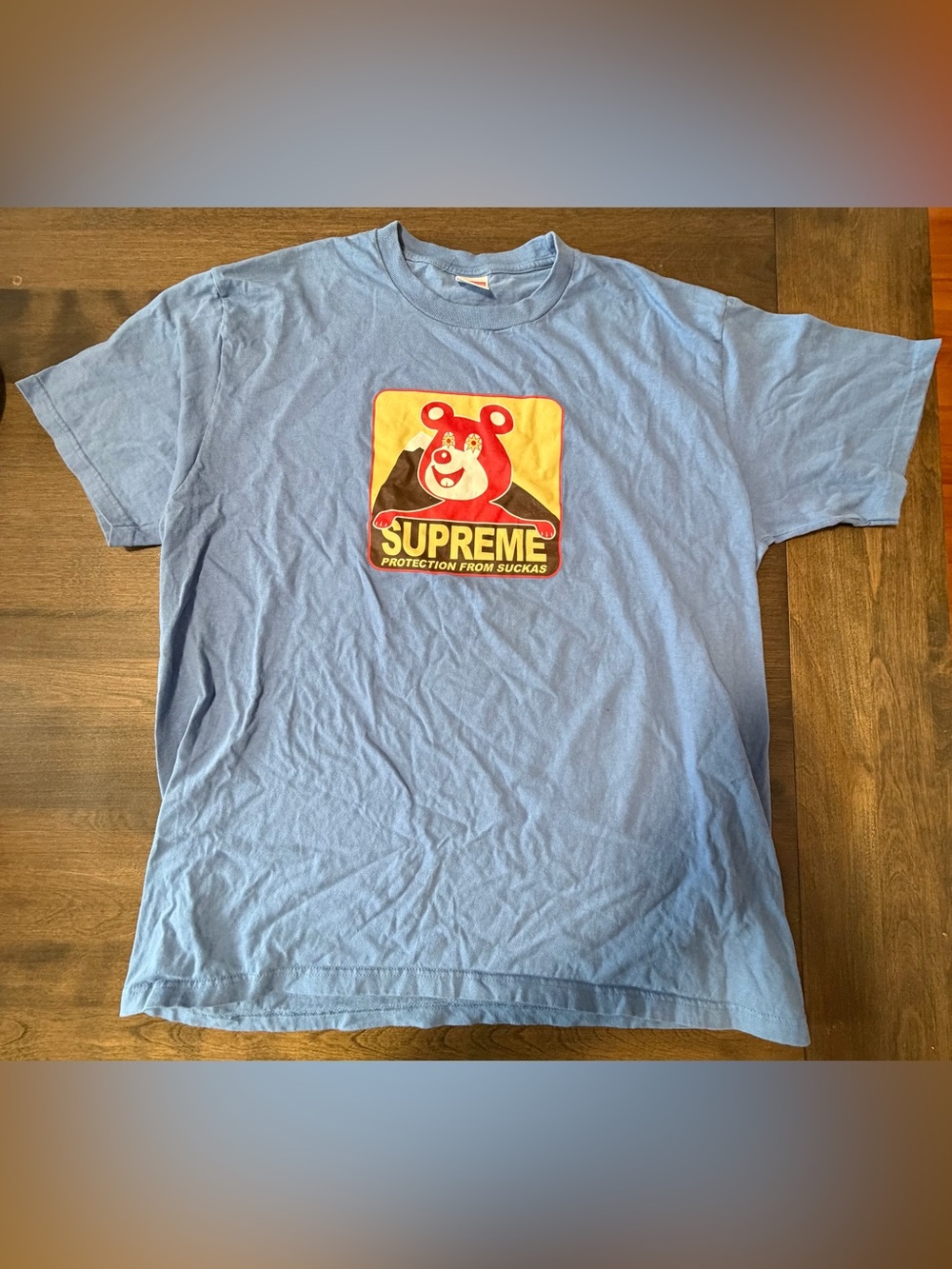 Supreme Light Blue Tee with Red & Yellow Bear Graphic
